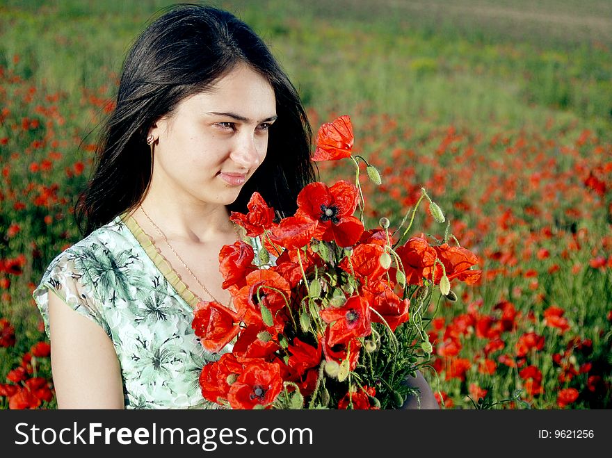 Girl on a red poppies field