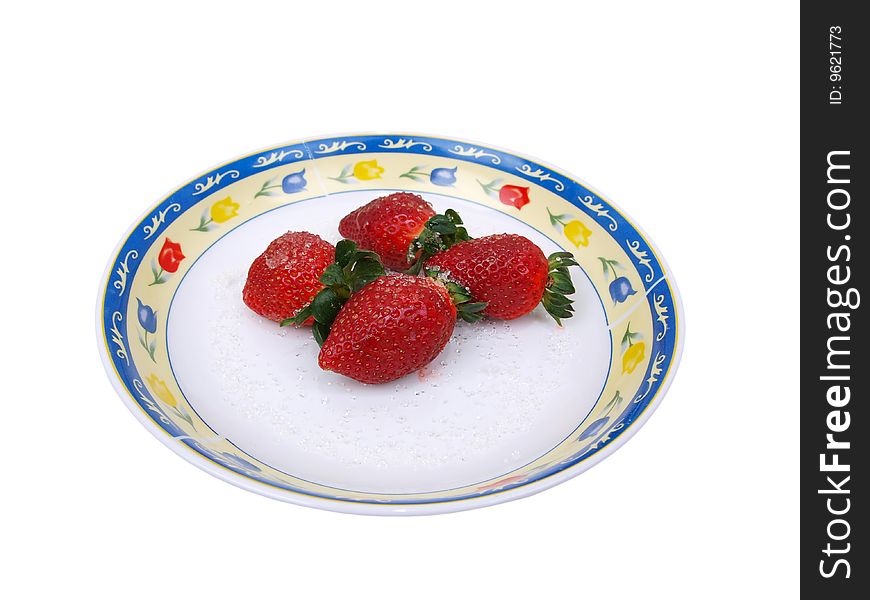 Full Front view of four fresh ripe strawberries sprinkled with course white sugar on colorful flower pattern decorated dish. Full Front view of four fresh ripe strawberries sprinkled with course white sugar on colorful flower pattern decorated dish.