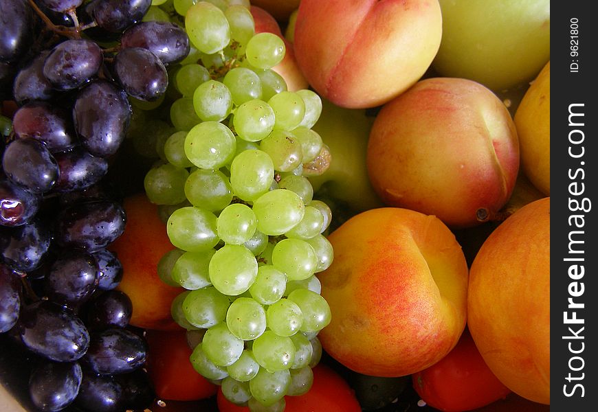 Two kinds of ripe grapes, juicy peach and sweet apricots very tasty!. Two kinds of ripe grapes, juicy peach and sweet apricots very tasty!