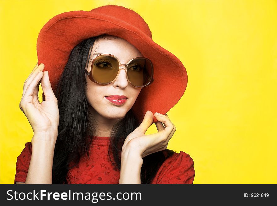 Portrait of young woman in sunglasses and red hat in retro style. Portrait of young woman in sunglasses and red hat in retro style