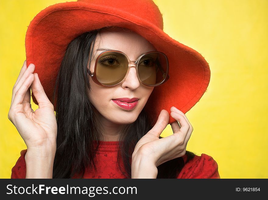 Portrait of young woman in sunglasses and red hat in retro style. Portrait of young woman in sunglasses and red hat in retro style