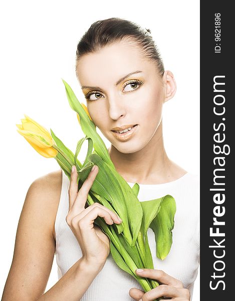 Portrait of young woman with yellow tulips