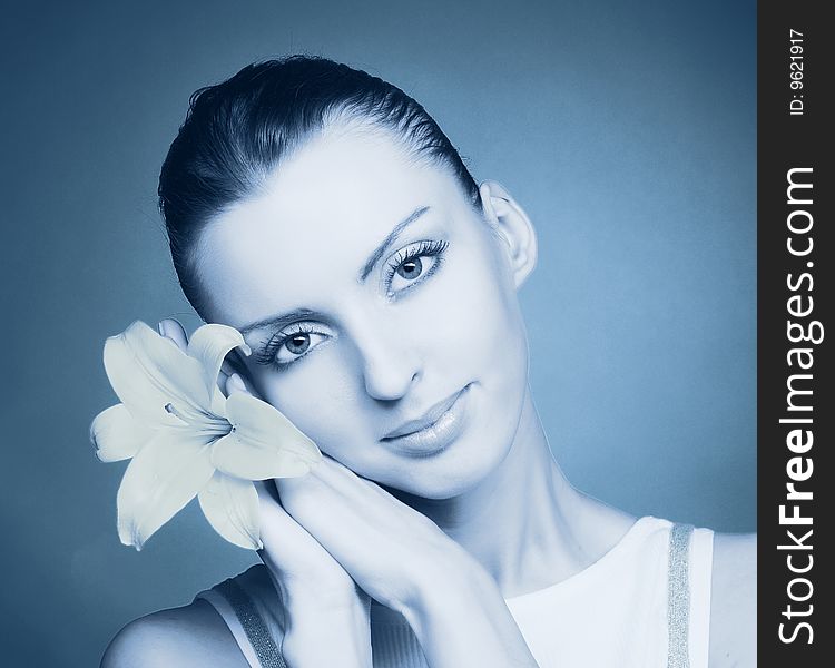 Portrait of young woman with yellow flowers in cold tones. Portrait of young woman with yellow flowers in cold tones