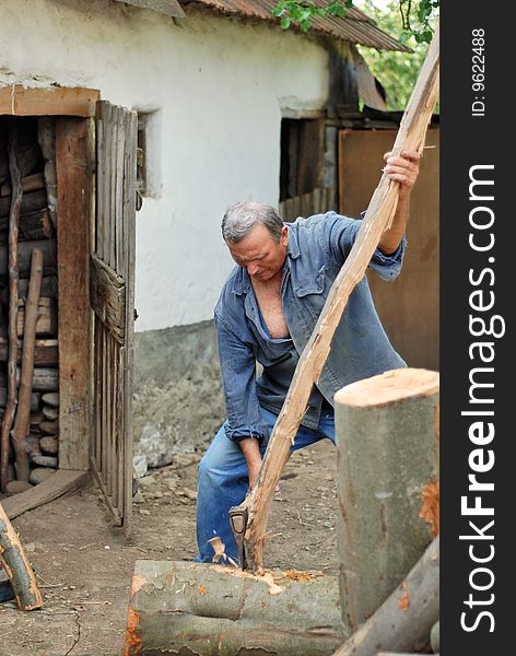 Man chopping woods with an axe