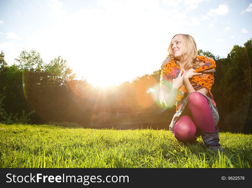 Beauty Woman Sitting On The Green Grass