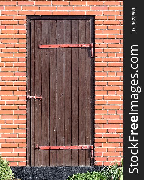 Old wooden door in a red brick house