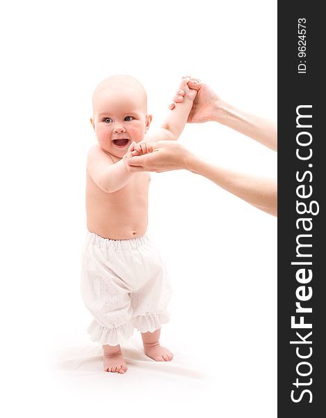 Cute happy baby girl with mother hands on white background