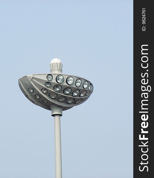 Stadium lights against a clear blue sky background