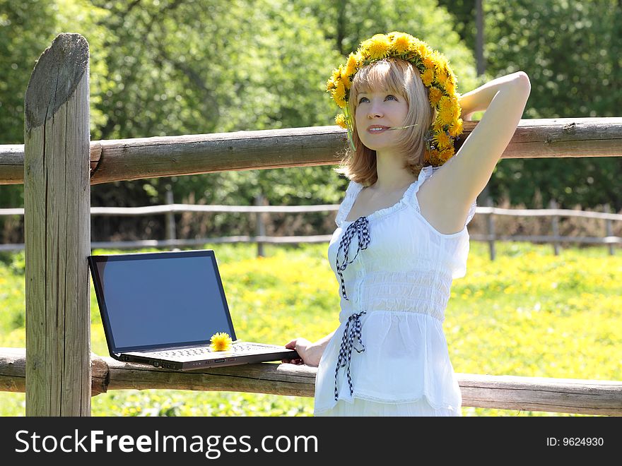 The girl with the computer on the nature. The girl with the computer on the nature