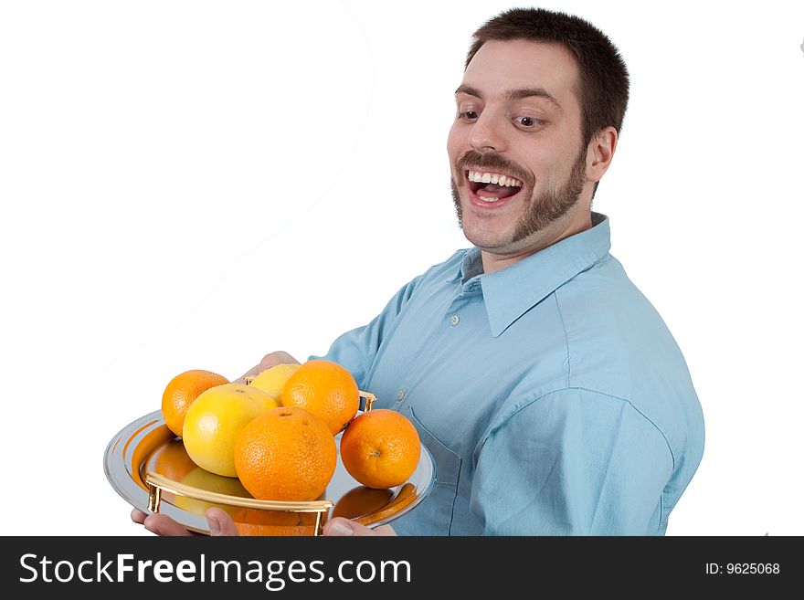 Happy young man holding fruit on a plate. Happy young man holding fruit on a plate