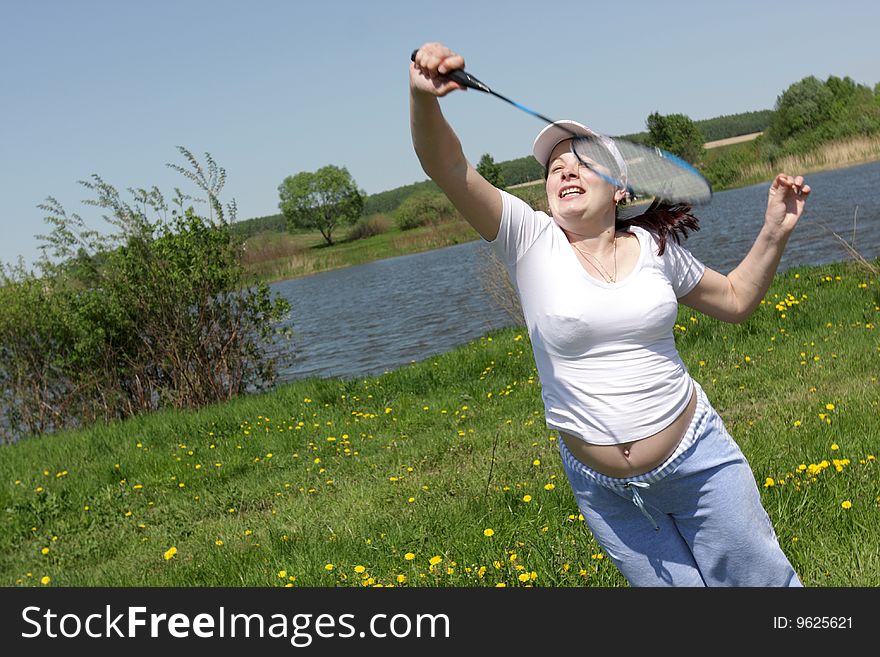 The expectant mother plays in Badminton on the riverside