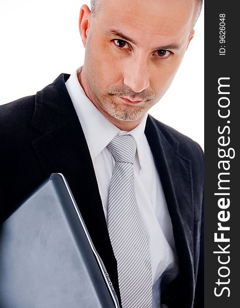 Businessman with a serious look on his face holding laptop. Businessman with a serious look on his face holding laptop