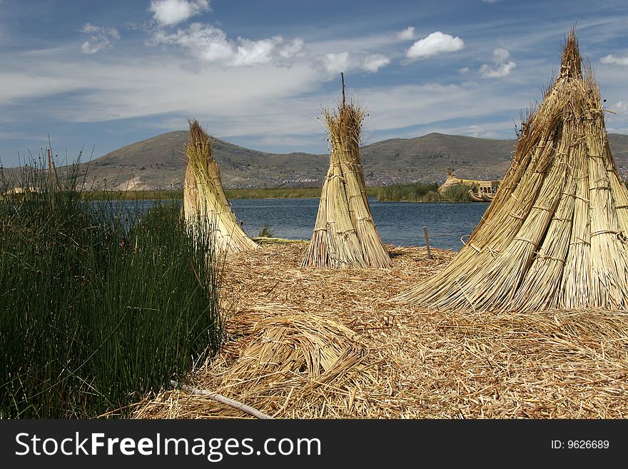 Stacks of reed on a floating island in lago de Titicaca in Peru