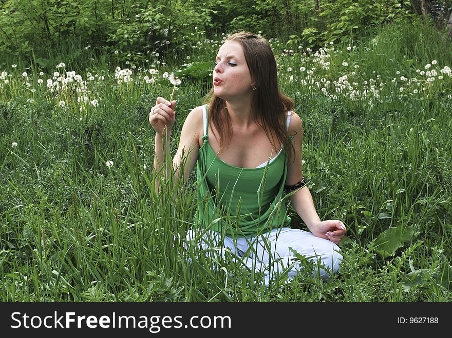 Beautiful girl  on summer lawn with dandelions. Beautiful girl  on summer lawn with dandelions