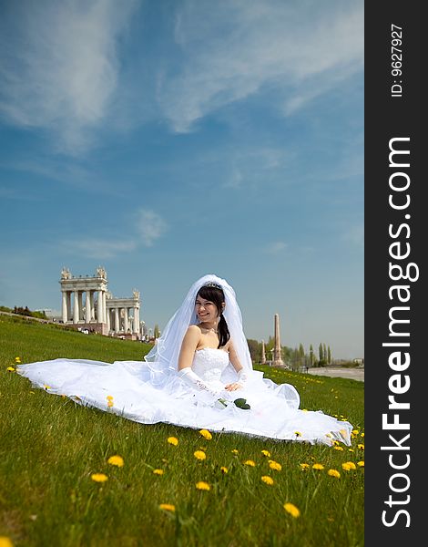 Pretty bride sit on the grass