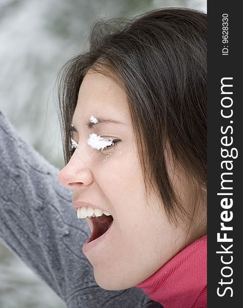 Pretty young woman with snow on face. Pretty young woman with snow on face