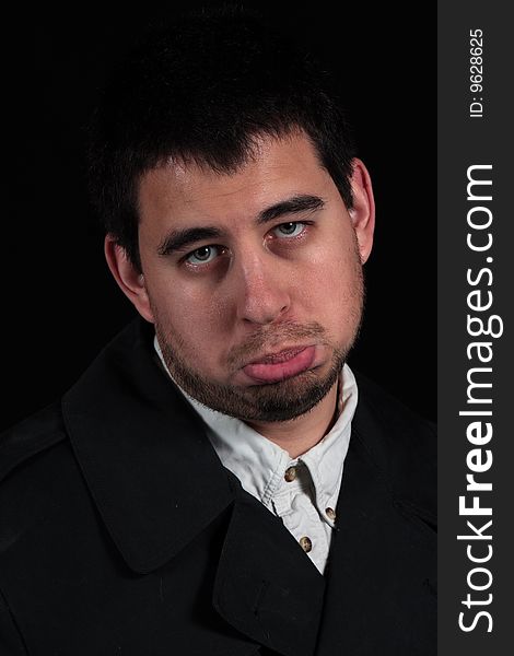 Pouting male portrait isolated on black background