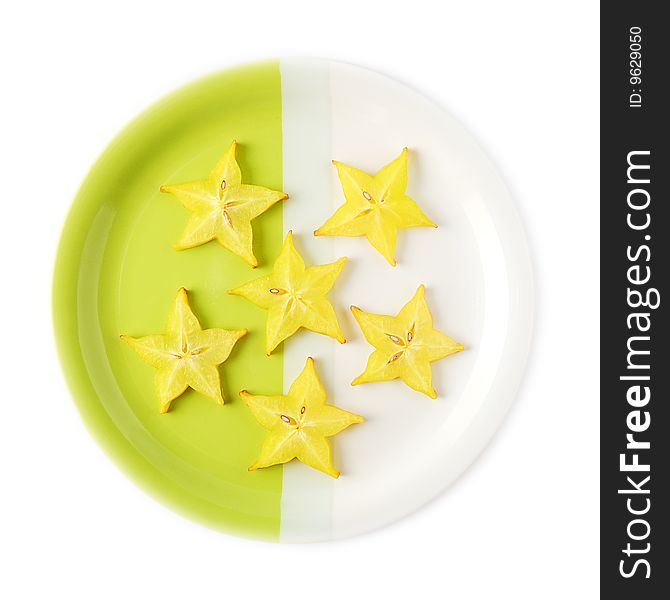 Slices of starfruit (carambola) on a two-colored plate. Slices of starfruit (carambola) on a two-colored plate