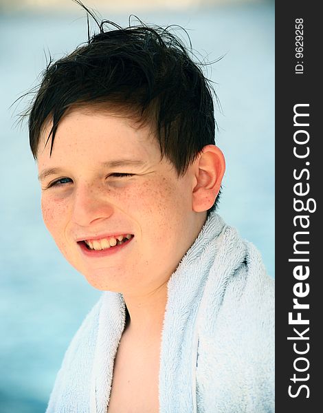Smiling boy in beach towel