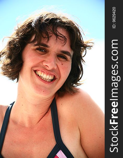 Woman smiling in swimsuit at the beach