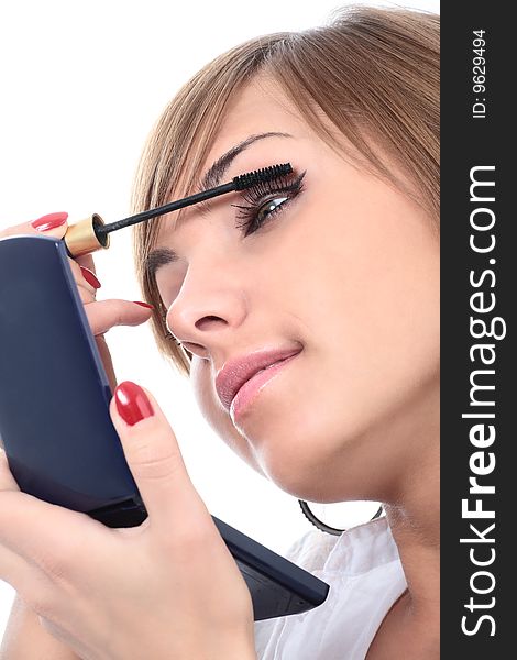 Close-up portrait of young beautiful brushing woman with mascara and mirror isolated on white. Close-up portrait of young beautiful brushing woman with mascara and mirror isolated on white