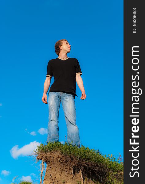 Man standing on a hill at the spring daytime. Man standing on a hill at the spring daytime