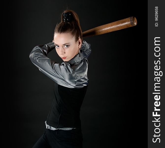 Young girl prepares to strike by baseball bat. Young girl prepares to strike by baseball bat