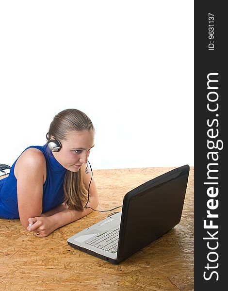 Teenage girl lying on the floor with laptop,isolated over white background. Teenage girl lying on the floor with laptop,isolated over white background