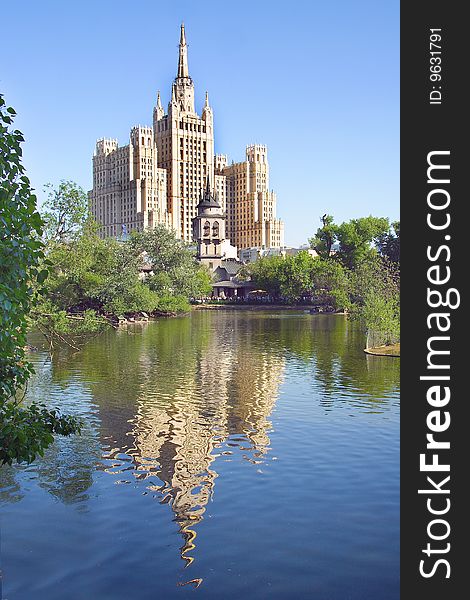 High building reflects under the zoo lake