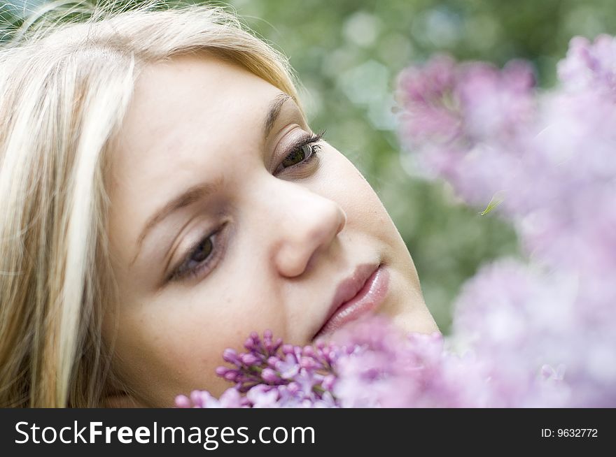 Portrait of a beauty young woman with lilac flowers