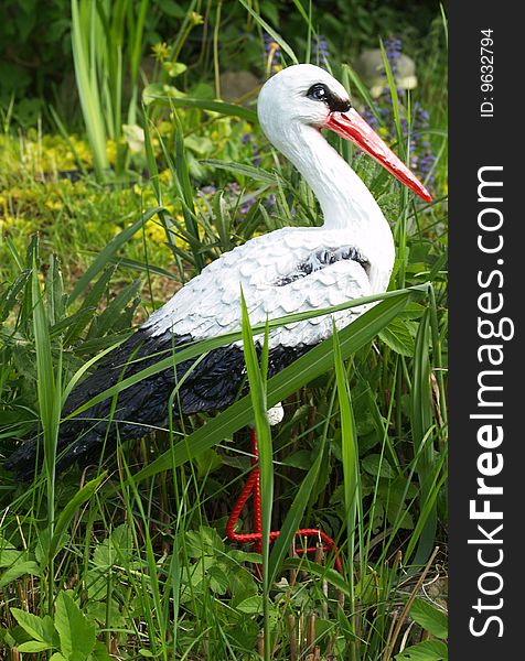 White stork little statue in garden