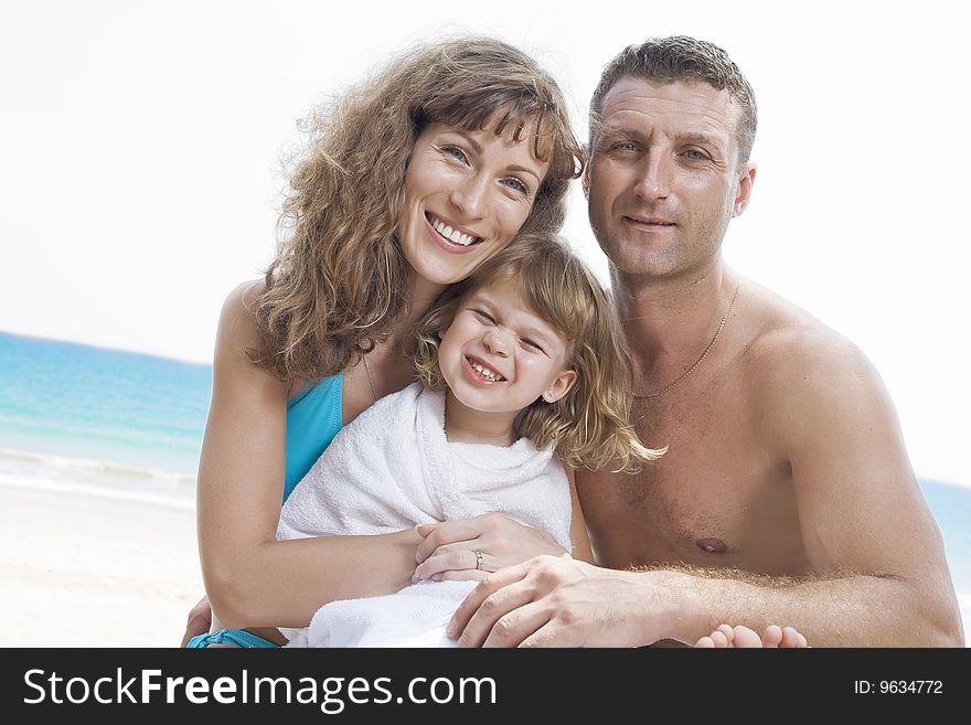 Portrait of young family having fun on the beach