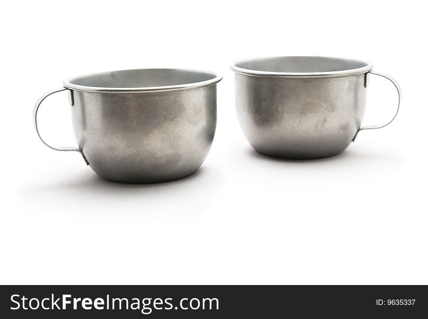 Two tinware cups with eyes