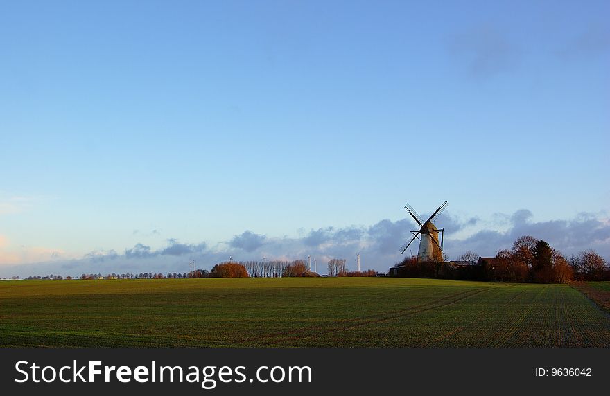 Morning light, traditional windmilland modern windmill generators