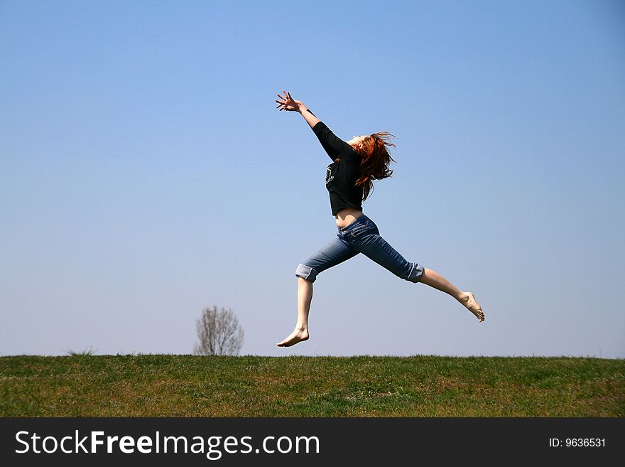 The girl taken in a jump like hanging in the air. The girl taken in a jump like hanging in the air