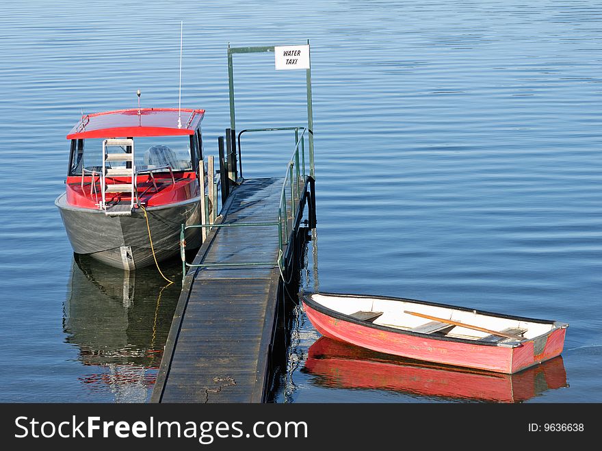 Speed boat and canoe at the jetty