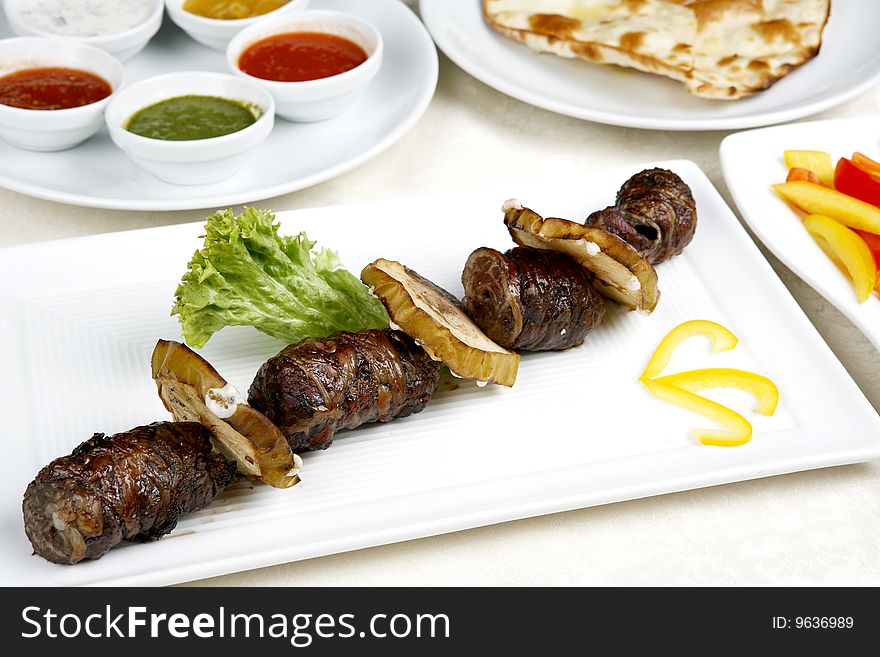 Appetizing Shish Kebab With Tomatoes And Greens