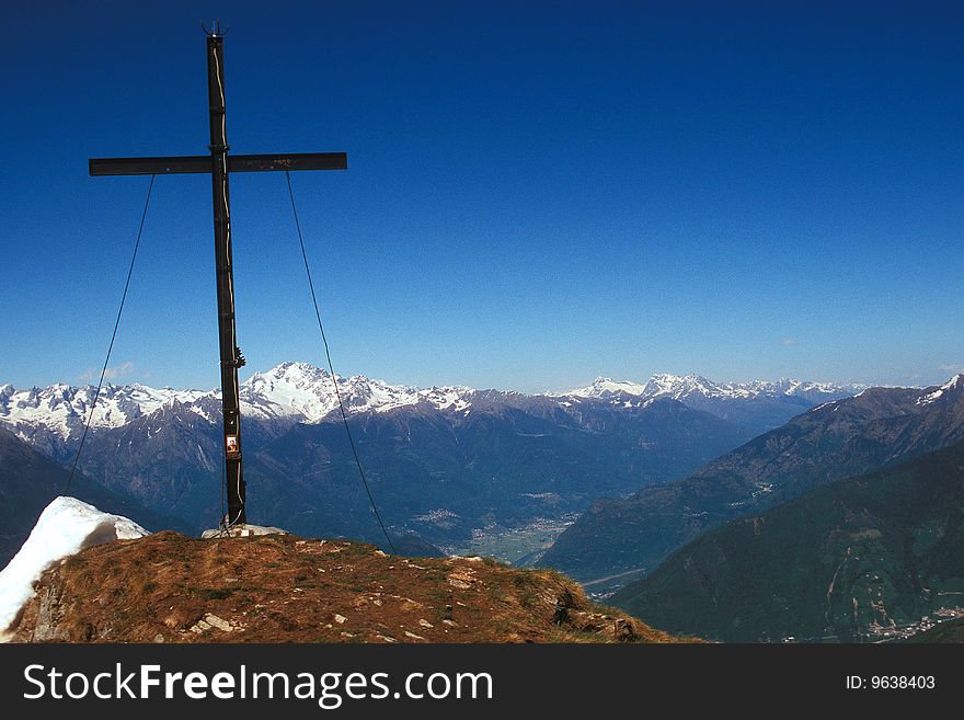 Cross on top of the mountain on the Rhaetian Alps (Sondrio - Italy)