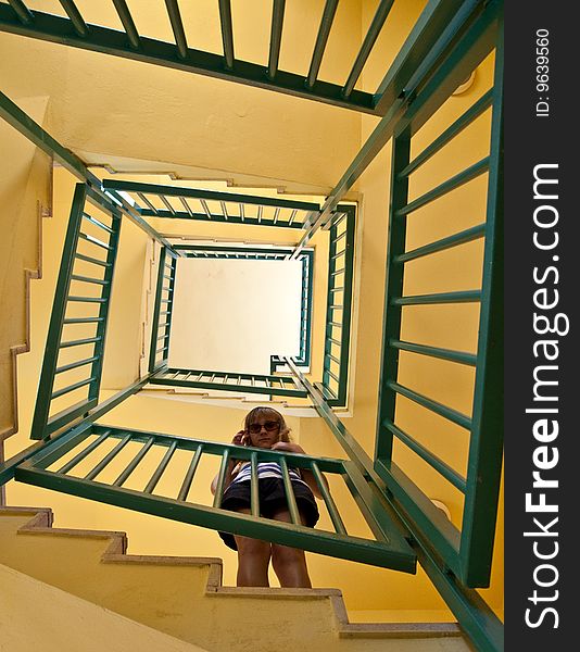 Girl Stands On The Spiral Staircase