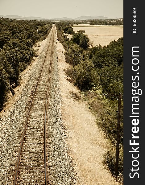 Railway track leading to the horizon in vertical composition