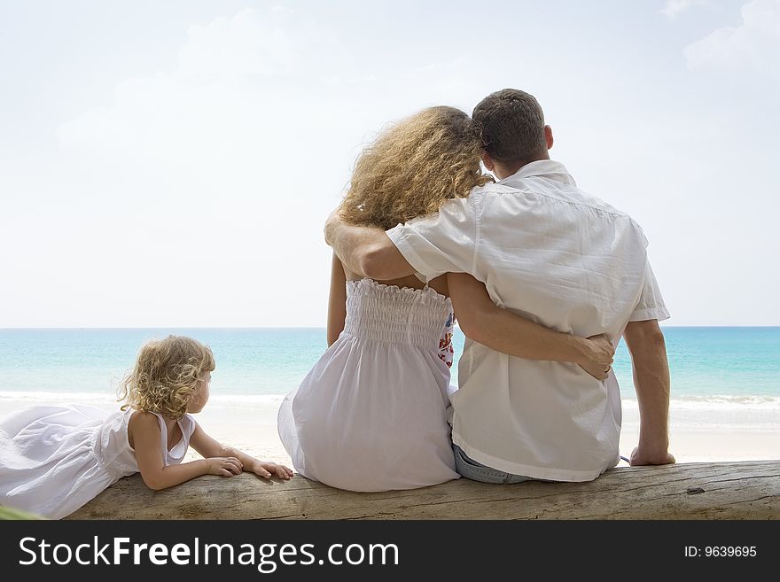 Portrait of young family having fun on the beach. Portrait of young family having fun on the beach