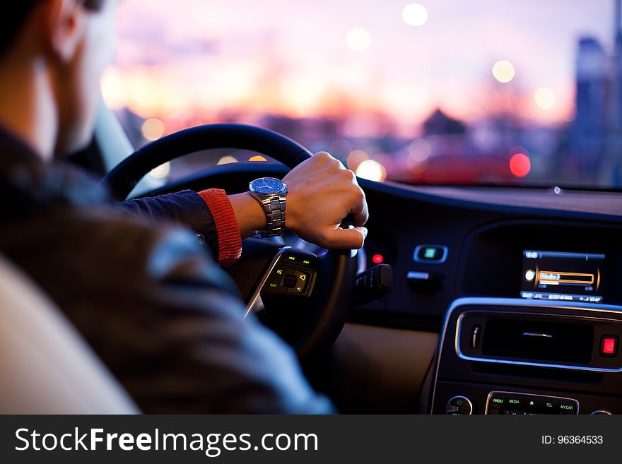 Person Wearing Black Shirt Driving Vehicle During Daytime