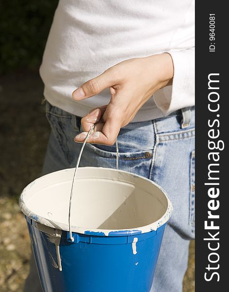 Woman Holding Paint Bucket Ready for Work