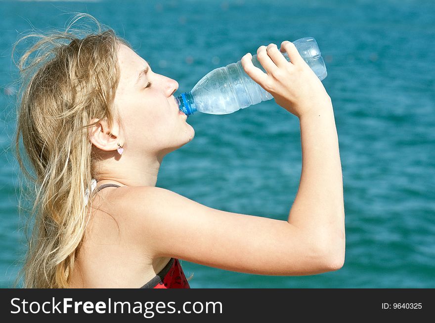 Girl drinking water from plastic bottles. Girl drinking water from plastic bottles