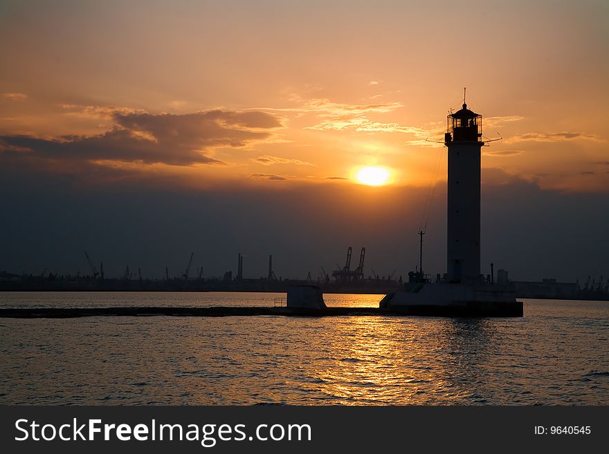 Silhouette of a lighthouse at dusk