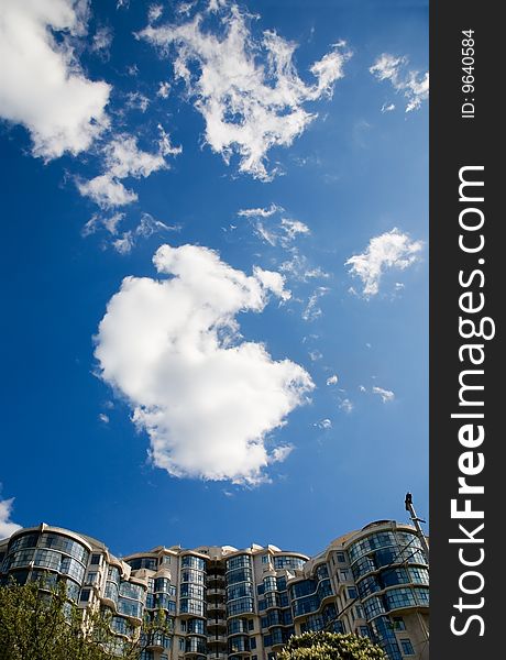 Generic modern building and cloudy sky