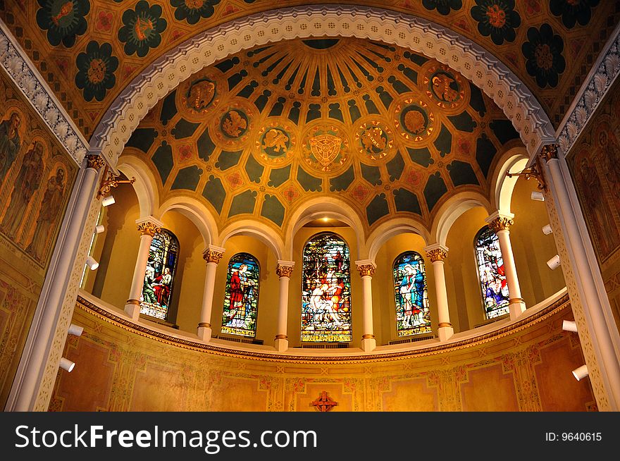 The beautiful lines and curves in the church combine harmoniously with the golden lighting and beautiful stained glass windows. The beautiful lines and curves in the church combine harmoniously with the golden lighting and beautiful stained glass windows