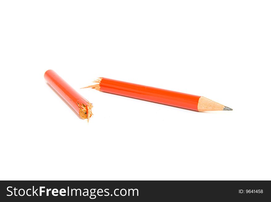 Red pencil snapped in two halfs on a white background. Red pencil snapped in two halfs on a white background