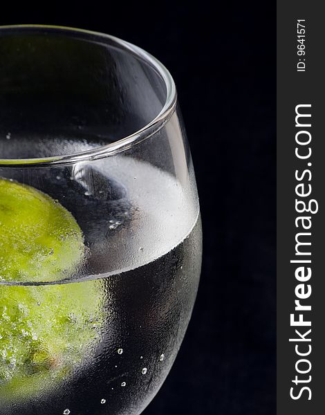 Closeup of a glass with sparkling water and lime. Closeup of a glass with sparkling water and lime