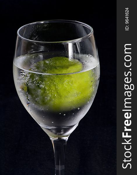 Closeup of a glass with sparkling water and lime. Closeup of a glass with sparkling water and lime